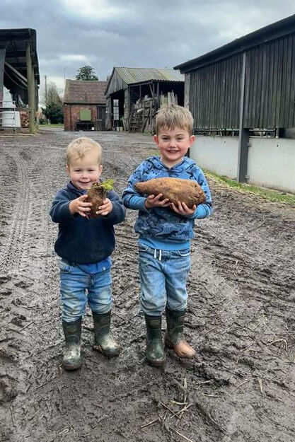 Little boys wearing warm wellies in green